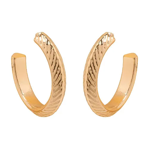 A pair of textured open gold hoop earrings with a subtle wavy design.