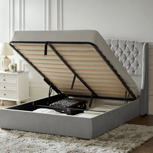 Queen Hydraulic-Lift Storage Bed with a tufted headboard and under-bed storage, featuring a mattress platform lifted by pistons. Ideal for maximizing space and organizing items like suitcases and blankets.