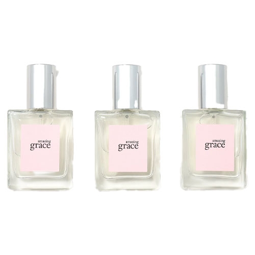 Three bottles of Amazing Grace perfume with a light pink label and silver cap.