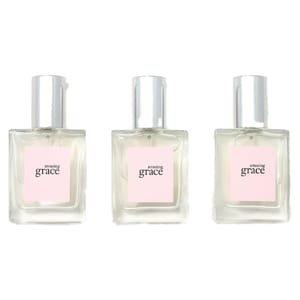 Three bottles of Amazing Grace perfume with a light pink label and silver cap.