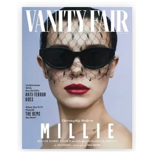 Vanity Fair magazine cover featuring an individual wearing a black lace veil, sunglasses, and red lipstick. Text highlights include topics like the NYPD's anti-terror boss, the Democratic Party, and \“Millie\“ related to \“Stranger Things.\“