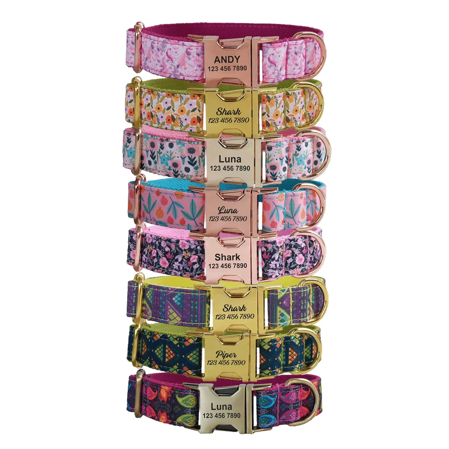 A variety of colorful pet collars with metal buckles are labeled with names like \“Andy,\“ \“Shark,\“ and \“Luna,\“ each featuring a unique patterned design.