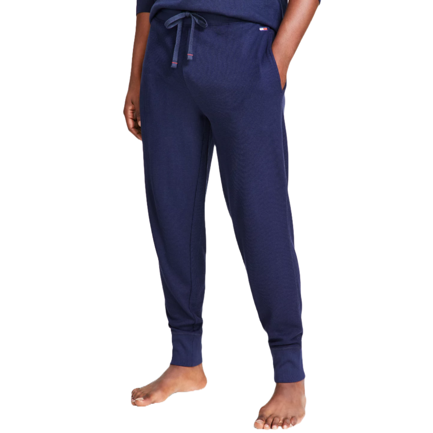 Navy blue thermal joggers from Tommy Hilfiger, featuring a drawstring waist, side pockets, and ribbed cuffs, ideal for comfortable and casual wear.