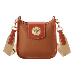 A brown leather crossbody bag featuring a flap with a circular gold-tone clasp and an adjustable beige strap with leather accents.