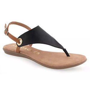 A black and brown sandal with a thong design and adjustable ankle strap, featuring a flat beige sole and metallic ring accent.