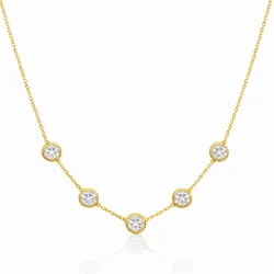 A delicate gold necklace featuring five evenly spaced, circular settings with clear gemstones on a fine chain.