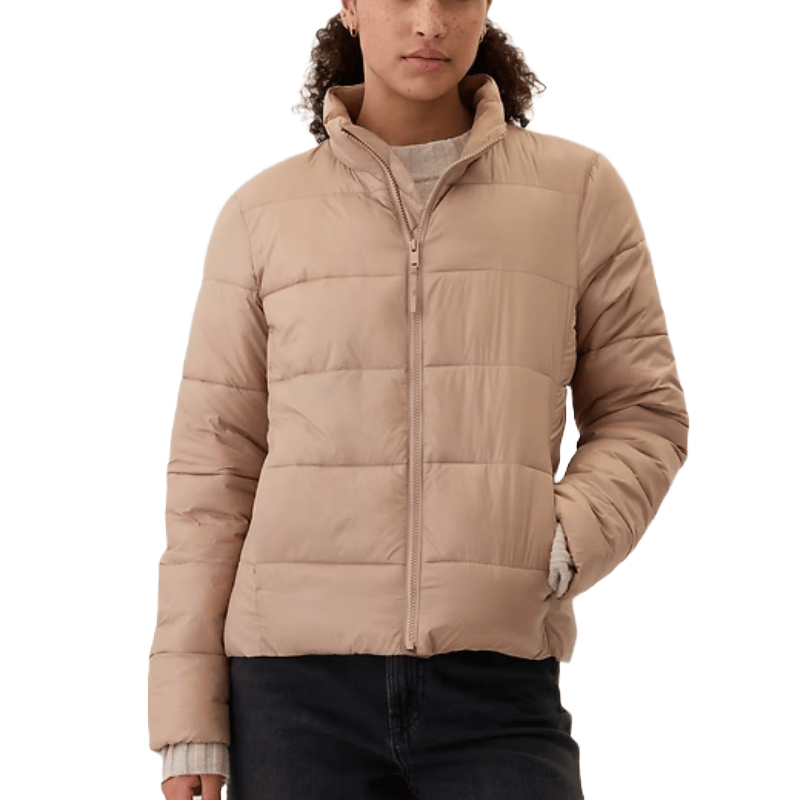 A beige quilted puffer jacket with a high collar and front zipper closure, featuring long sleeves.