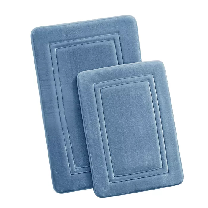 Two rectangular memory foam bath mats in light blue, featuring a quilted border design.