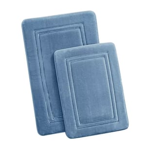 Two rectangular memory foam bath mats in light blue, featuring a quilted border design.