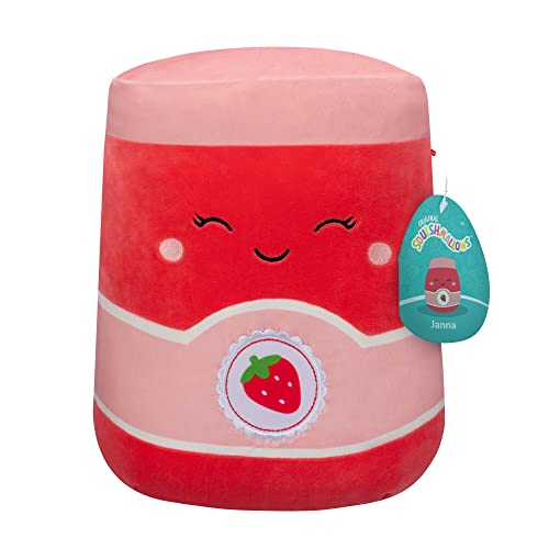 This is a Squishmallow named Janna designed to look like a jar of strawberry jam, featuring a smiling face with closed eyes, rosy cheeks, and a label with a strawberry image.