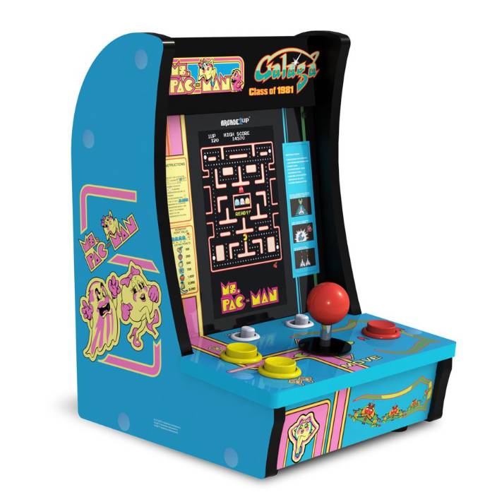 A compact arcade machine features Ms. Pac-Man, Galaga, and Galaxian games, with classic joystick and button controls, vibrant blue sides, and retro artwork.