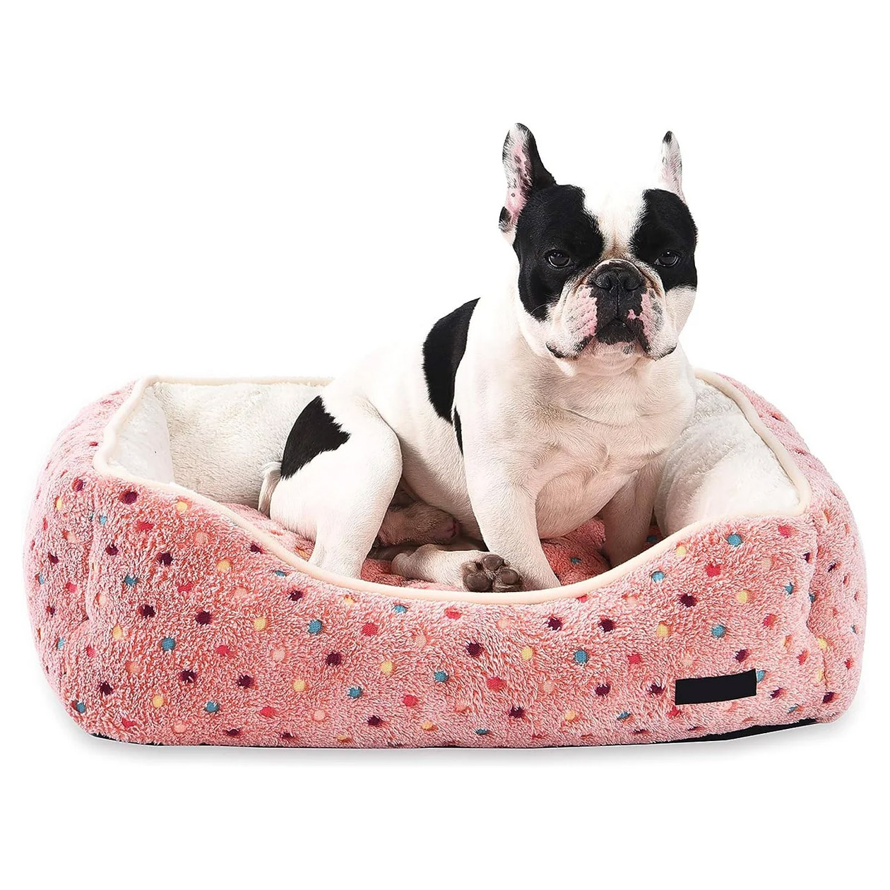 A rectangular pet bed with raised sides, featuring a pink doughnut pattern and a plush interior.