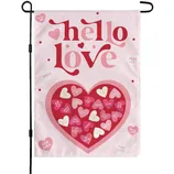 A garden flag with \“hello love\“ and various heart-shaped candies featuring phrases like \“XOXO\“ and \“MISS YOU\“ on a pink background, designed for Valentine's Day.