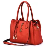 A stylish red handbag with dual handles, a detachable shoulder strap, gold-tone hardware, and zipper detailing on the side.