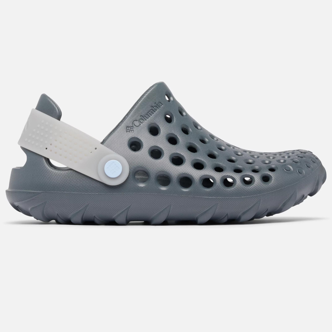 A gray foam clog-style shoe with a white adjustable strap and multiple ventilation holes.