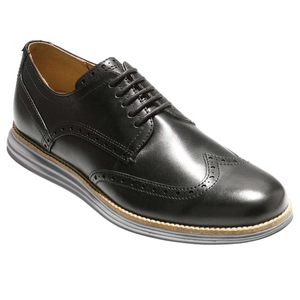 Black leather wingtip brogue shoe with perforated detailing and a cushioned sole.