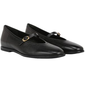 Black leather Mary Jane flats with a rounded toe, a slim adjustable strap featuring a gold buckle, and a flat sole. Suitable for a classic and comfortable look.