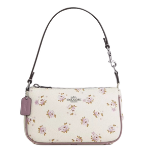 A white floral patterned shoulder bag with a detachable brown strap and a purple tag.