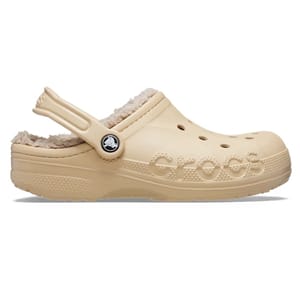 Beige Crocs clog with a fuzzy liner and a branded strap across the heel.