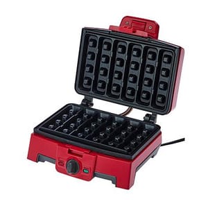 Red waffle maker with a rectangular grid design, featuring a temperature control knob and indicator lights on the front.