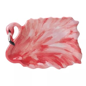 A pink ceramic plate shaped like a flamingo with detailed feathers and a small black and white beak.