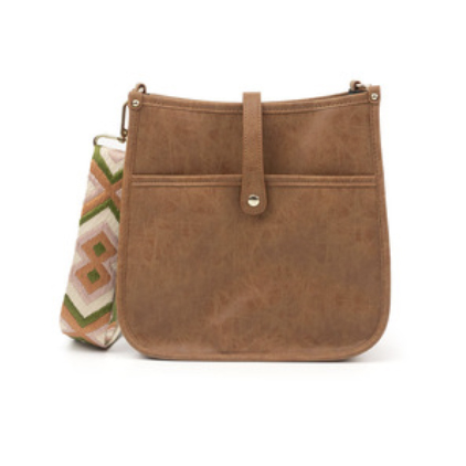 Brown courier bag with a fold-over strap and button closure, featuring a detachable multicolored woven guitar strap with geometric patterns.