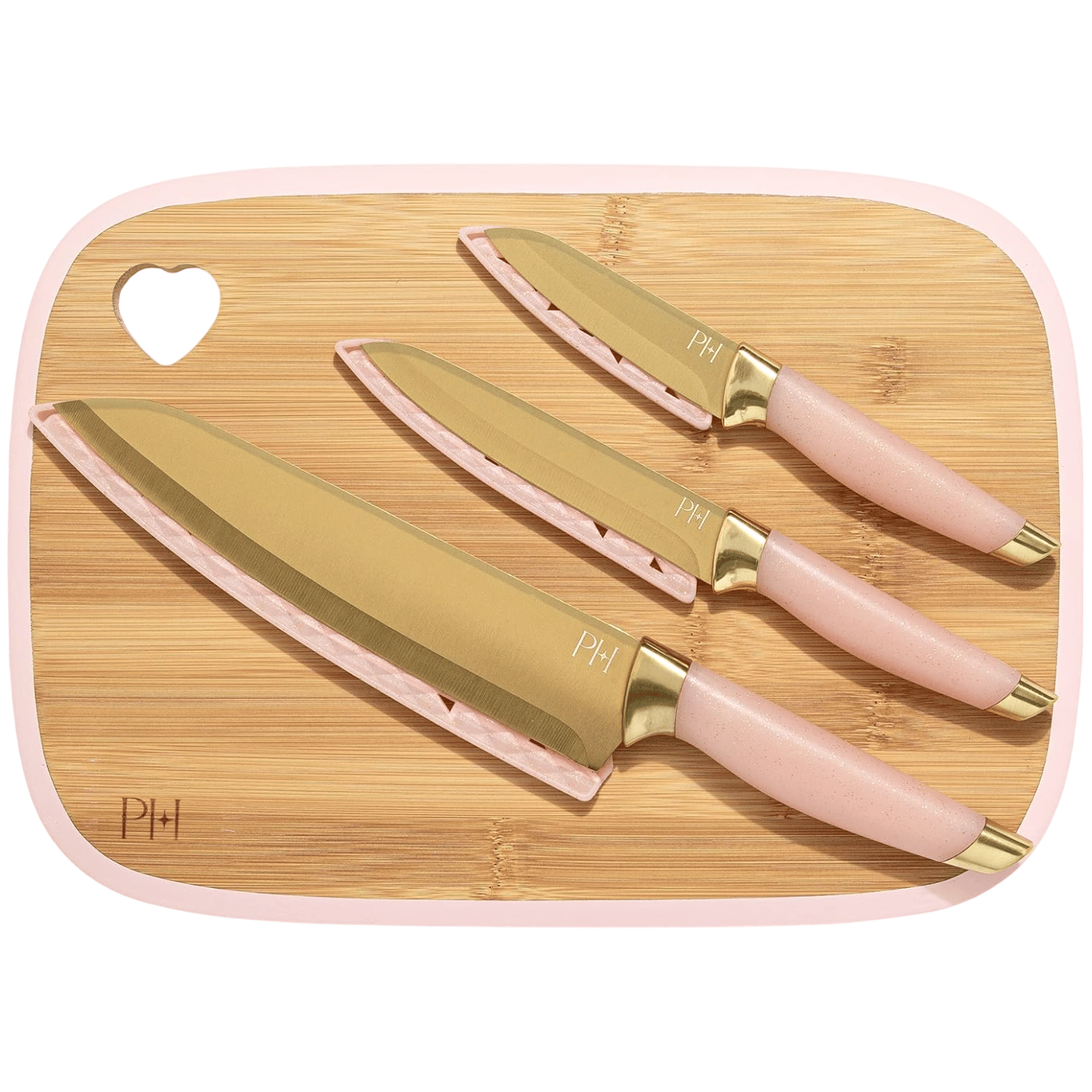 Knife set with golden blades and pink handles, placed on a bamboo cutting board with a heart-shaped cutout.