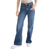 A person wearing high-waisted, wide-leg blue jeans paired with white sneakers and a cropped gray top.