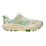 A white and beige athletic shoe with green accents, featuring a thick Vibram sole for enhanced traction and durability.