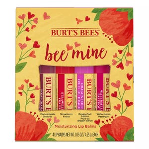Burt's Bees Valentine Lip Balm Set includes four moisturizing lip balms in Pomegranate, Strawberry, Dragonfruit Lemon, and Watermelon flavors, each weighing 0.15 oz (4.25 g), presented in a heart-themed package labeled \“bee mine.\“