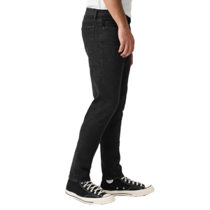 Black straight-fit jeans with a five-pocket design, paired with black and white high-top sneakers.