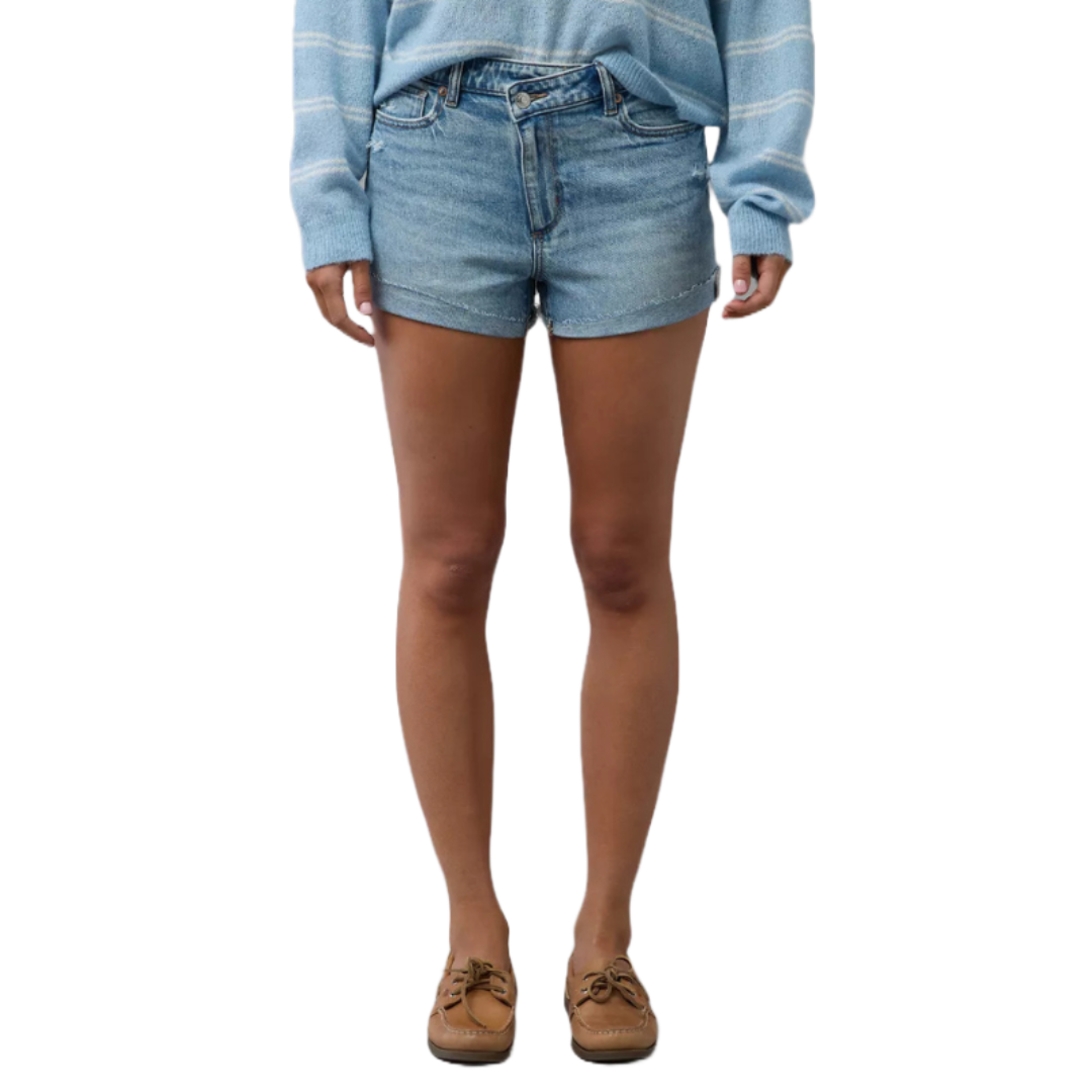 The AE Stretch Ripped Denim Mom Short features light blue denim with a slight stretch, a high waist, and a casual ripped design. Paired here with a striped blue sweater and tan loafers.