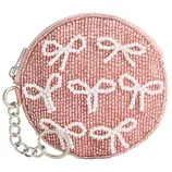 Round pink coin purse adorned with white beads shaped like bows, featuring a zipper closure and a metal keychain attachment.