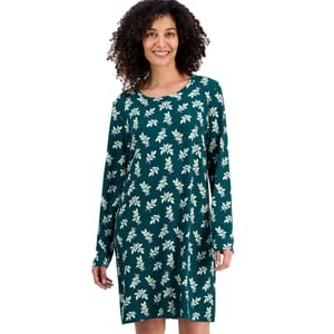 A woman is wearing a teal, long-sleeve dress featuring a floral pattern.