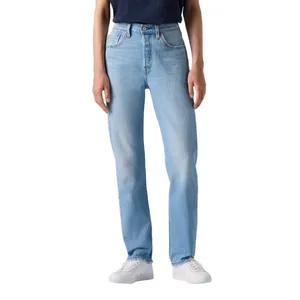 A person wearing light blue straight-leg jeans, a dark shirt, and white sneakers.
