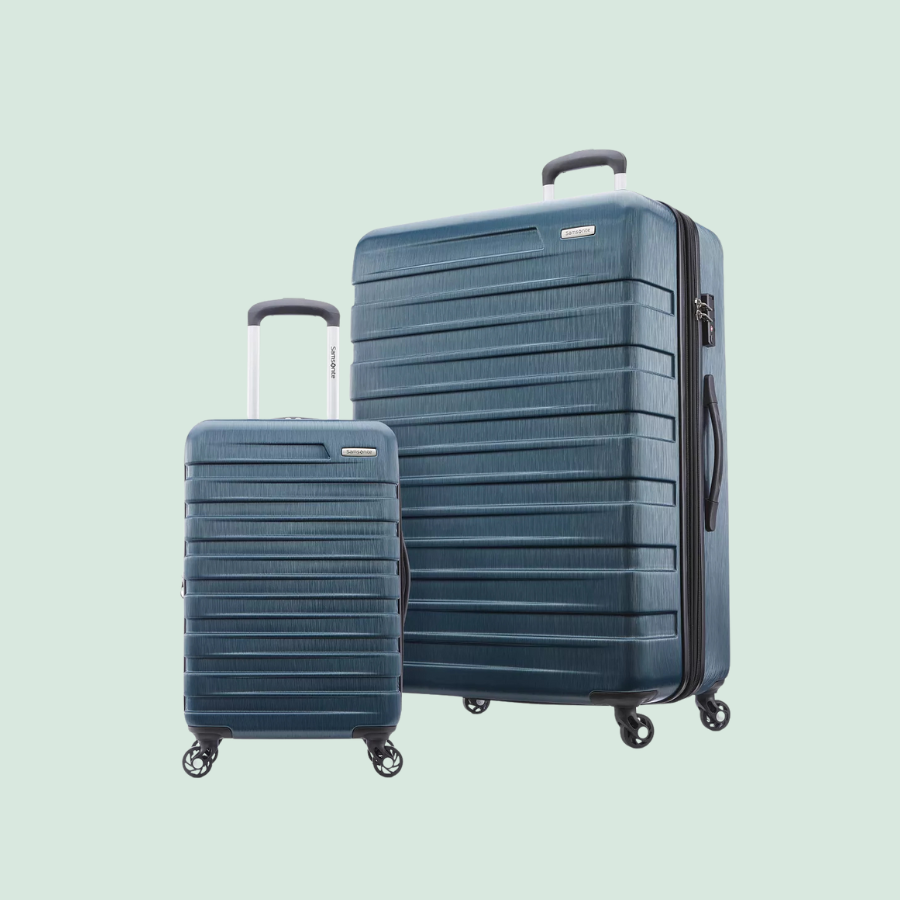 Two hard-shell suitcases with a ribbed texture, featuring extendable handles and four spinner wheels, one larger and one smaller, in a blue color.