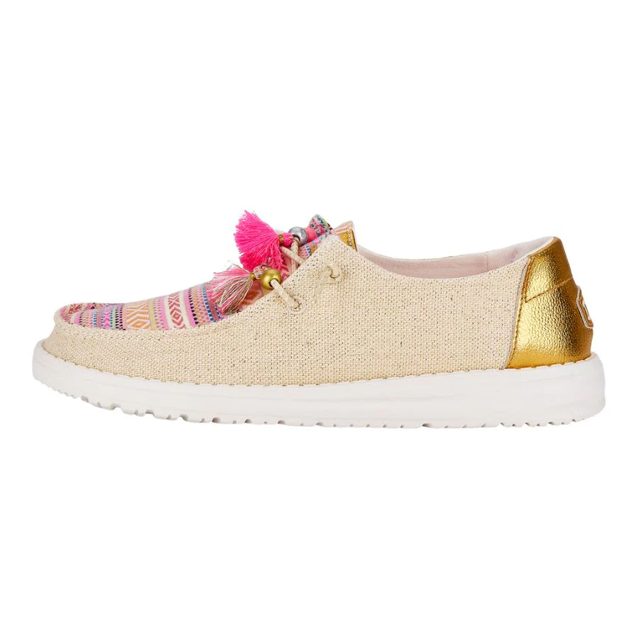 Casual espadrille-inspired shoe with a beige upper, gold-tone heel patch, and vibrant tassels.