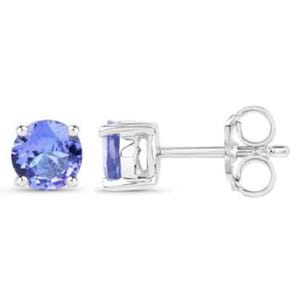 Round-cut tanzanite stud earrings set in a four-prong sterling silver mount with a simple post and butterfly backing. The tanzanites exhibit a deep blue-purple hue.