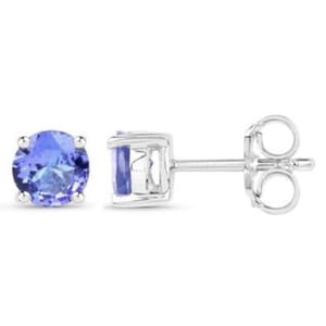Round-cut tanzanite stud earrings set in a four-prong sterling silver mount with a simple post and butterfly backing. The tanzanites exhibit a deep blue-purple hue.