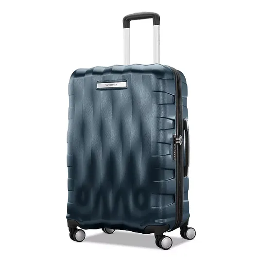 A dark blue hardshell suitcase with a textured design, extendable handle, and four wheels for easy mobility.