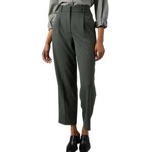 A person wearing high-waisted, dark green, tailored pants paired with a light gray blouse and black slip-on shoes.