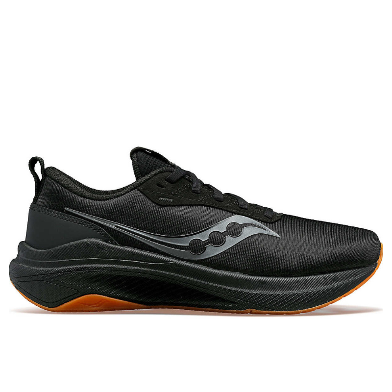 The Saucony Freedom Crossport is a black athletic shoe featuring a sleek design with a low-cut profile, a cushioned sole, a distinctive gray logo on the side, and an orange outsole, suitable for running and various sports activities.