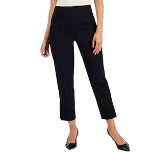 High-rise black pants with a straight fit and slit cuffs falling slightly above the ankle, paired with black flats.