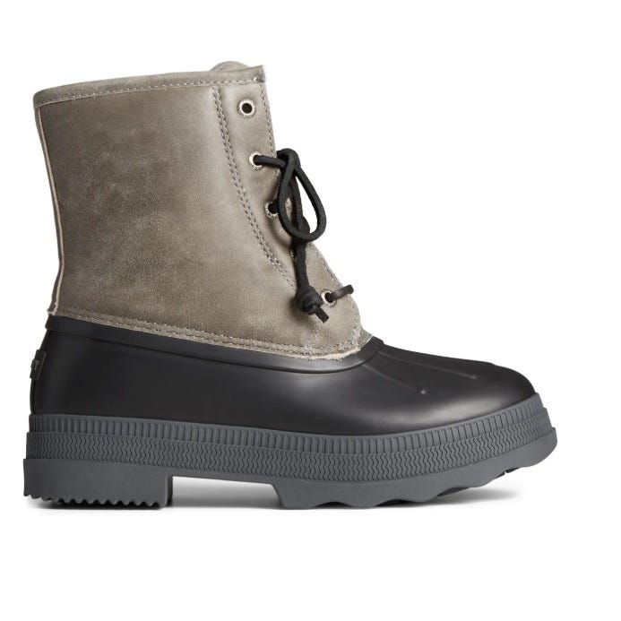 A waterproof boot with a gray suede upper and black rubber lower, featuring black laces and a textured sole for traction.