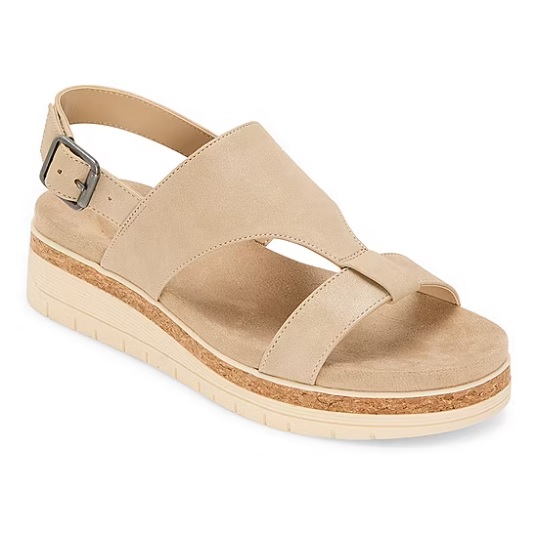 Beige platform sandal with a cork-like midsole, featuring a thick cross strap design, an open toe, and an adjustable ankle strap with a buckle.