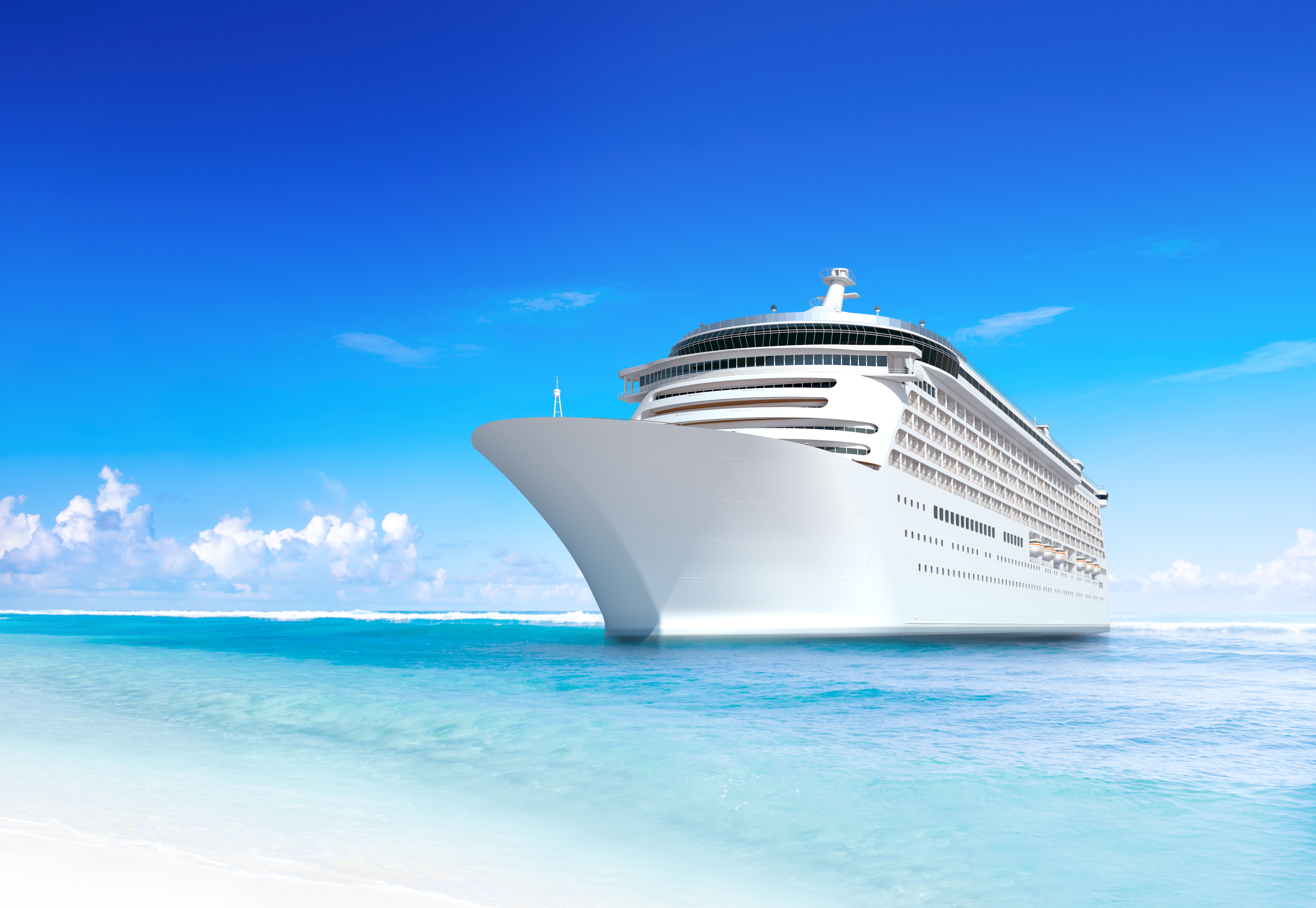 A large white cruise ship on a bright blue sea with a clear sky in the background.