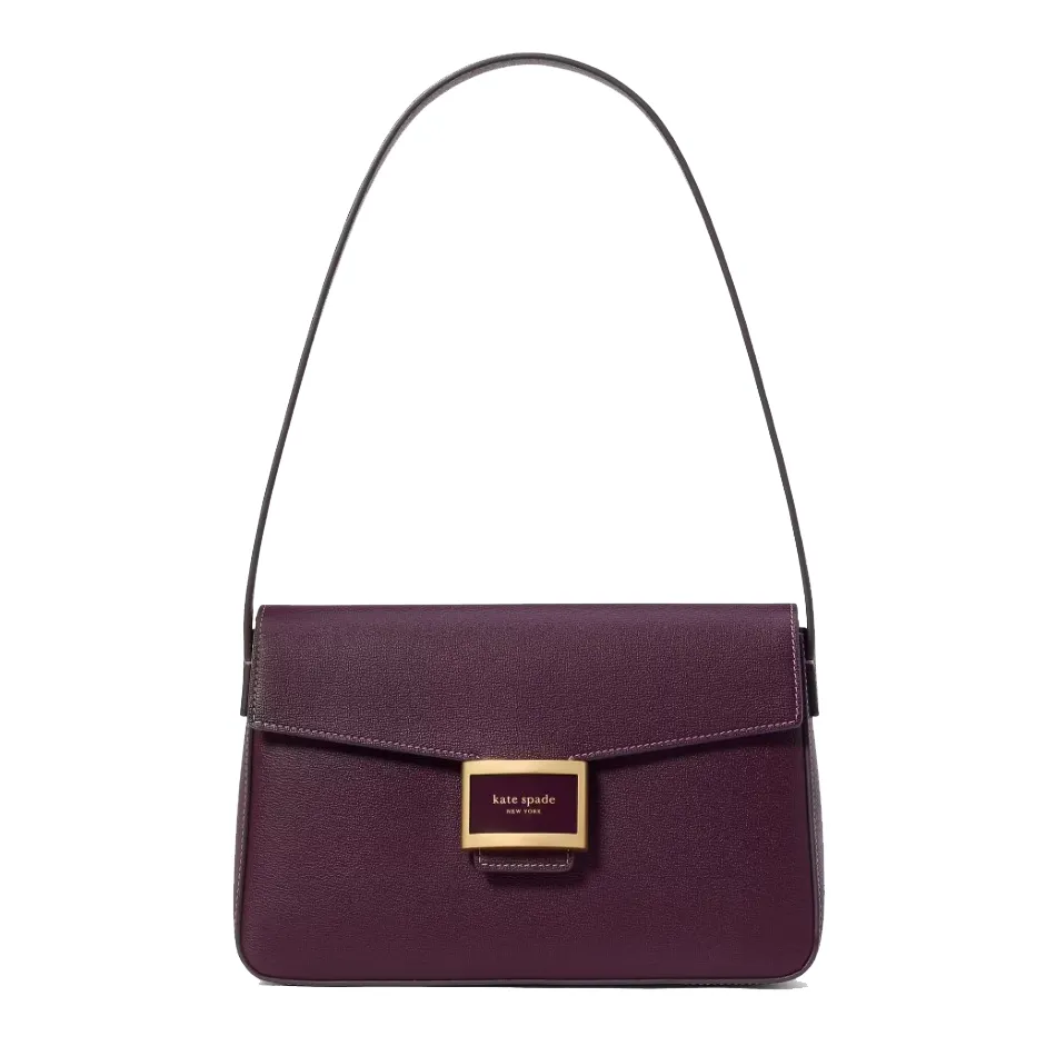 Purple shoulder bag with a structured design, featuring a front flap and a gold-tone Kate Spade New York logo plaque.