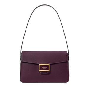 Purple shoulder bag with a structured design, featuring a front flap and a gold-tone Kate Spade New York logo plaque.