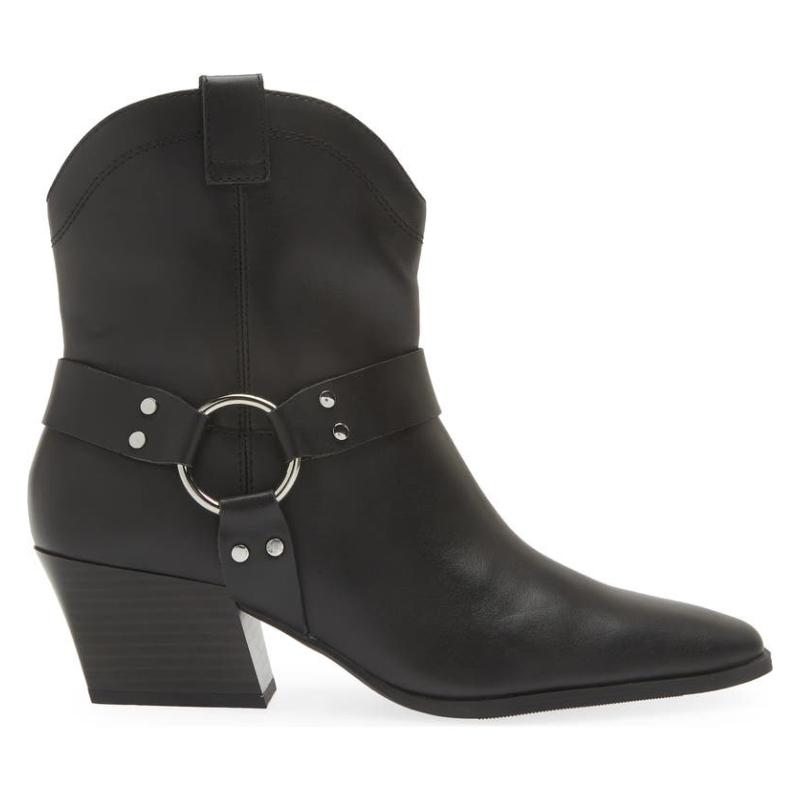 Black western-style ankle boots with a pointed toe and block heel. Features a decorative harness strap with silver hardware, including a circular ring and rivets.