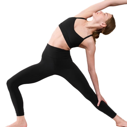 A person is performing a yoga pose wearing a black sports bra and high-waisted leggings.